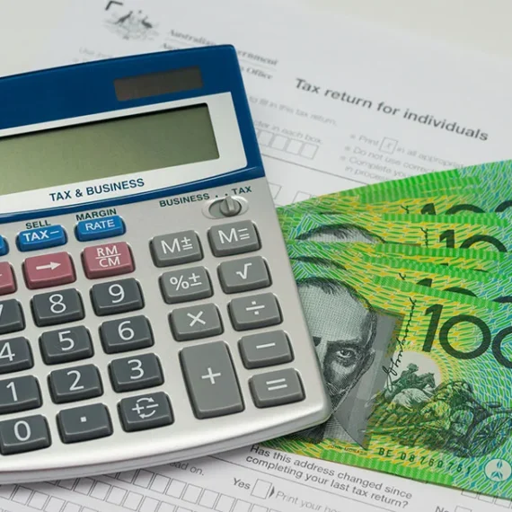 calculator and australian dollar bill used as a guide when preparing tax returns in Australia
